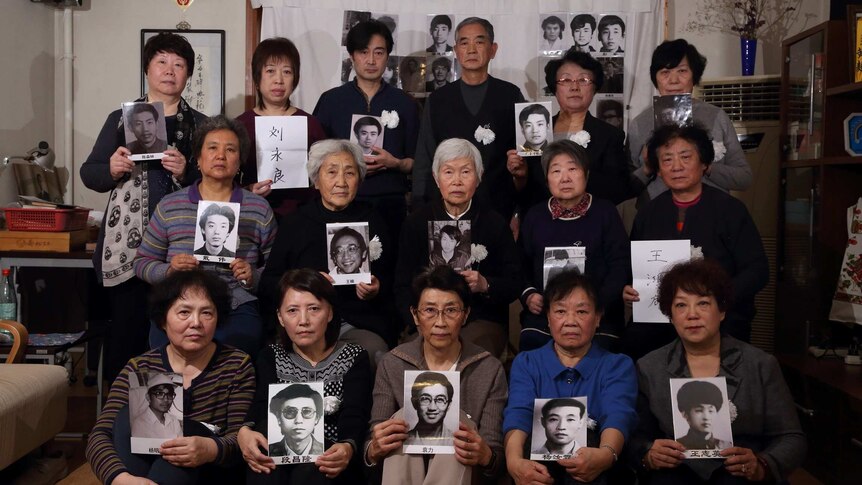 Members of the group Tiananmen Mothers hold up photos of their loved ones, who were killed in the 1989 Tiananmen Square massacre
