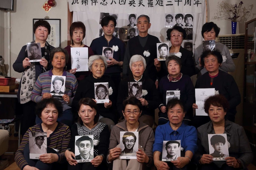 Members of the group Tiananmen Mothers hold up photos of their loved ones, who were killed in the 1989 Tiananmen Square massacre