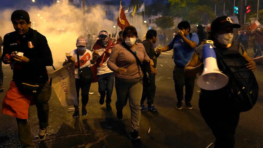 A group of people running away from an explosion