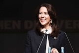 Crown Princess Mary of Denmark stands at a lectern.