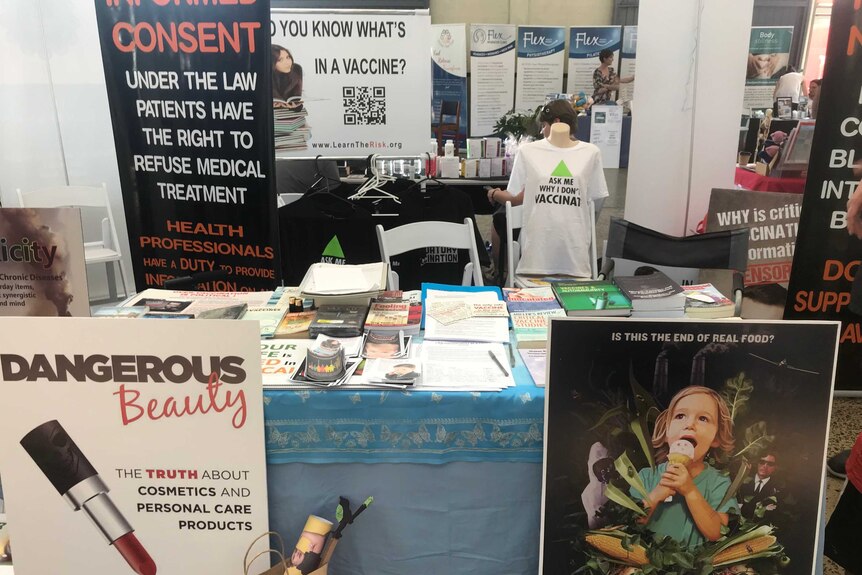 Anti-vaxxers stall with signs.