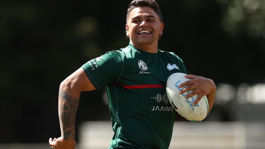 A man smiles during rugby league training 