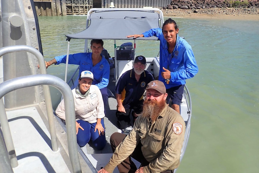People involved in the release of rare Bulwer's petrel Buggelugs in a 5m aluminium boat at a jetty