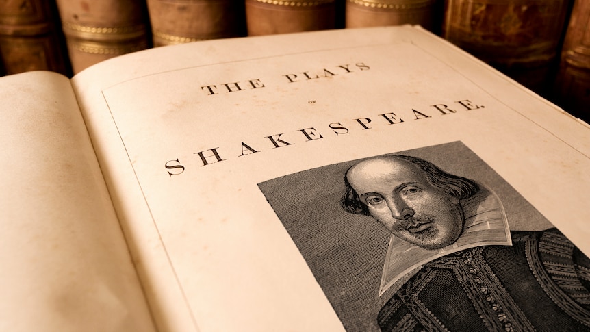 A book open to the title page reading "The Plays of William Shakespeare" and a woodblock print of the playwright