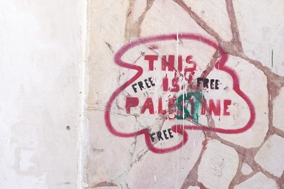 Writing on a wall that says 'this is Palestine'