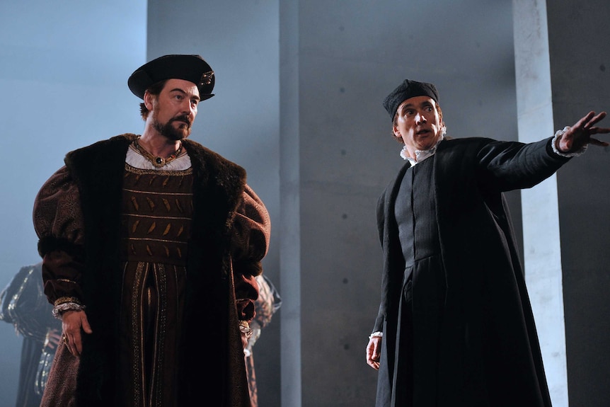 Two actors playing King Henry VIII and his right-hand man Thomas Cromwell on a stage