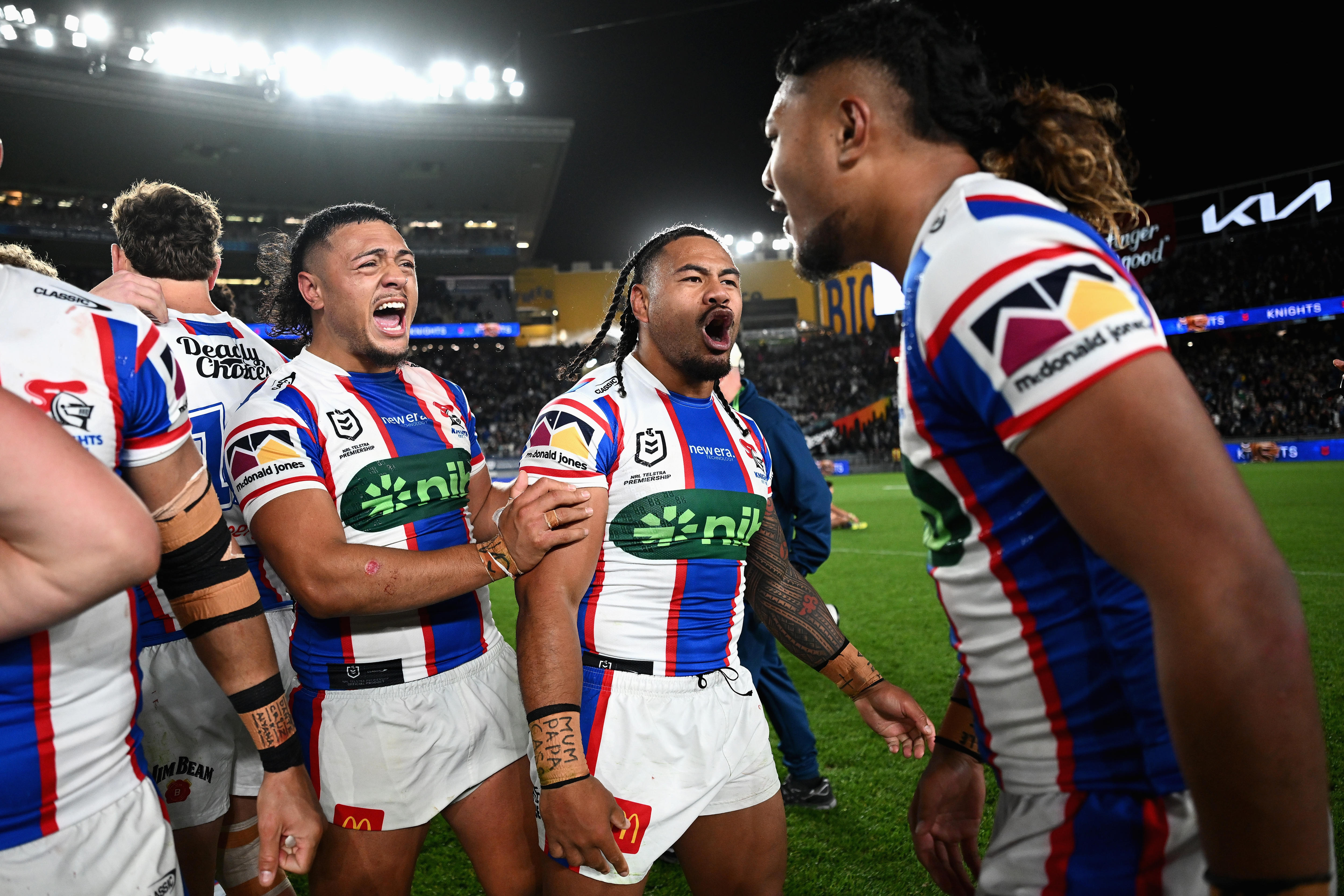 A group of players celebrate an NRL finals win