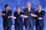 The leaders of Brunei, Laos, Malaysia and Burma hold hands for a photo session at ASEAN.