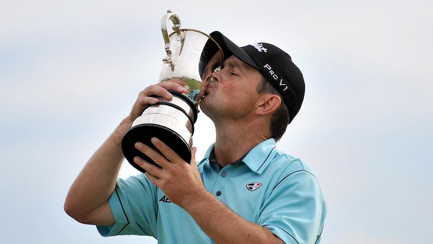 Greg Chalmers kisses the trophy after Australian Open win.
