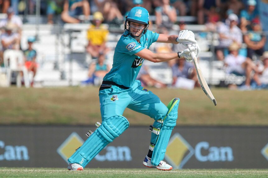 A Brisbane Heat WBBL player watches a batting stroke to the off side against Adelaide Strikers.