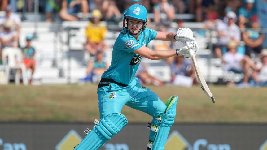 A Brisbane Heat WBBL player watches a batting stroke to the off side against Adelaide Strikers.