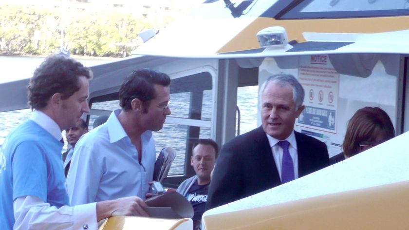 Liberal MP Malcolm Turnbull helps out with campaigning on a ferry in Brisbane on July 22, 2010.