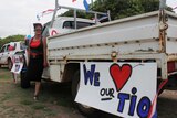 A woman stands in front of a ute in a Darwin carpark.