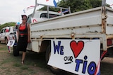 A woman stands in front of a ute in a Darwin carpark.