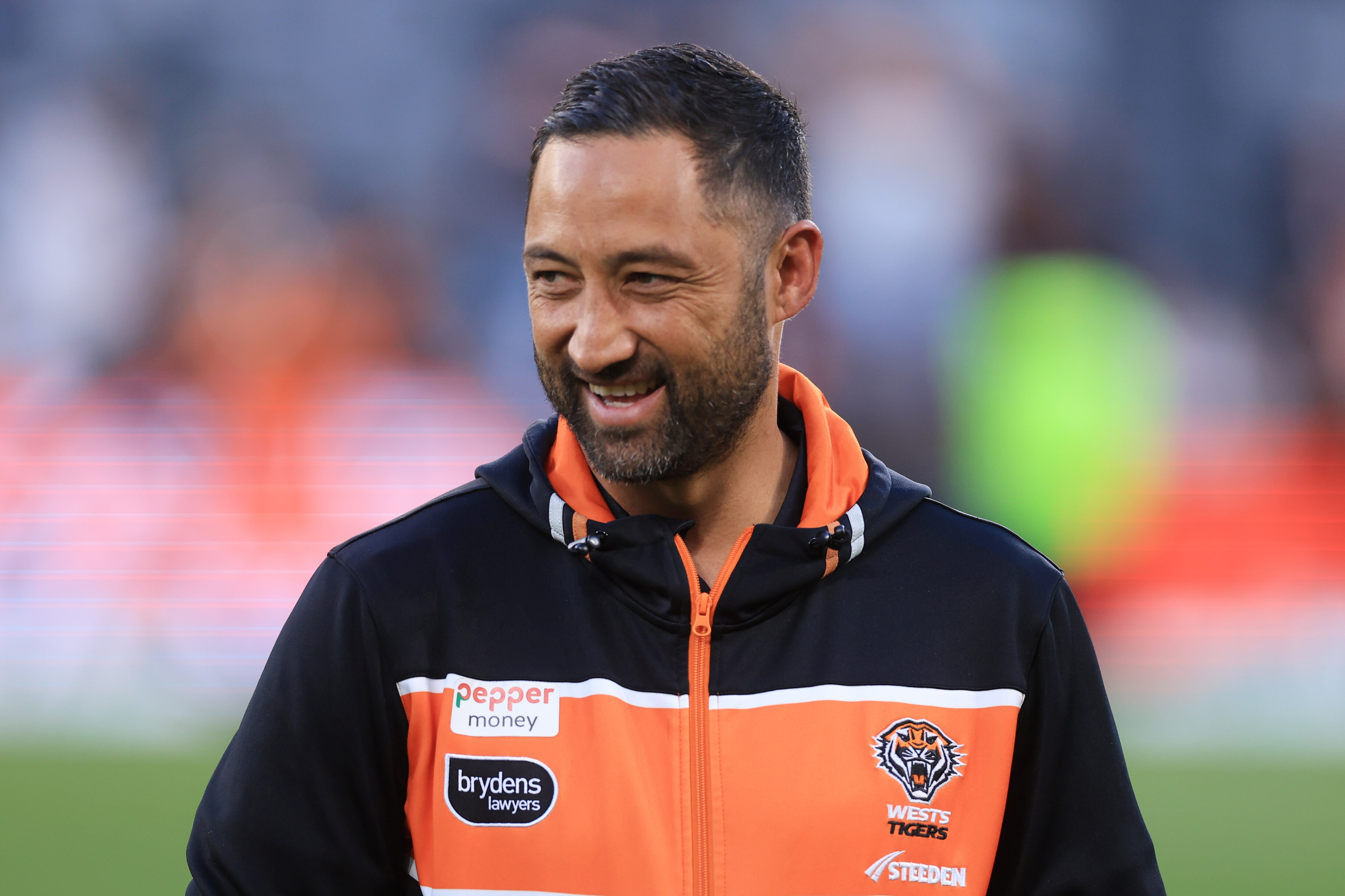 Benji Marshall smiles as he looks to his right after Wests Tigers defeated the Dolphins in their NRL match.