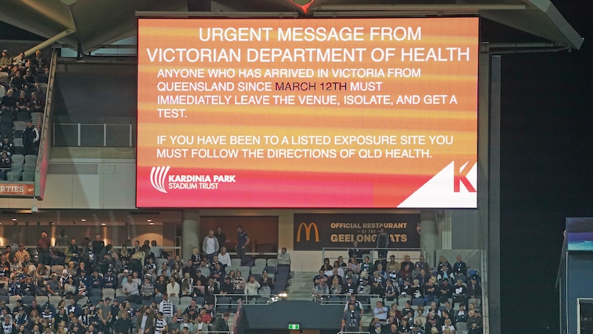 COVID-19 message on large screen at Kardinia Park