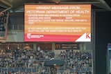COVID-19 message on large screen at Kardinia Park