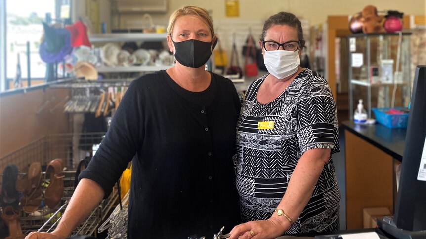 Two women in shop with masks