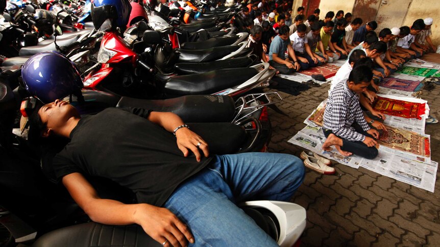 A man sleeps on motorbikes
