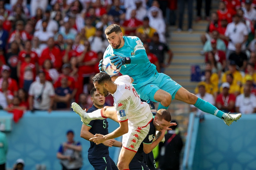 Ryan leaps high over a defender to claim the ball.