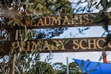 A sign reads 'BEAUMARIS PRIMARY SCHOOL' behind gum leaves.