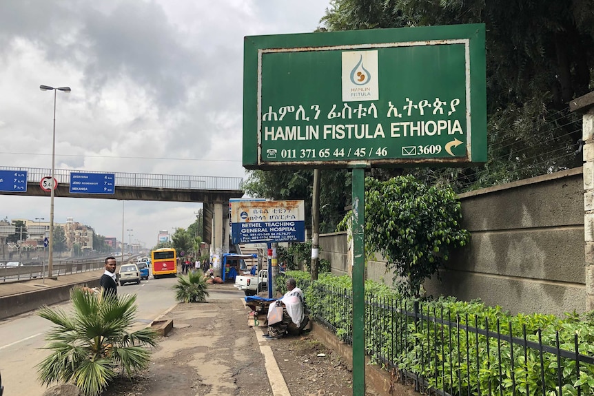 A green road sign that reads "Hamlin Fistula hospital"