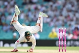 Matthew Wade performs a handstand while attempting to keep wicket