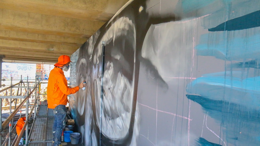 Guido van Helten working on the glasses as part of the installation.