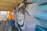 Guido van Helten working on the glasses as part of the installation.