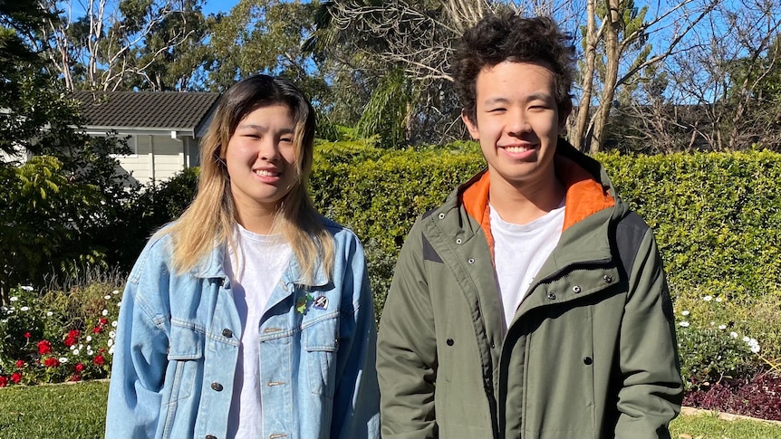 A woman and man stand next to each other smiling.