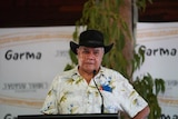 Mick Dodson speaks at a lectern