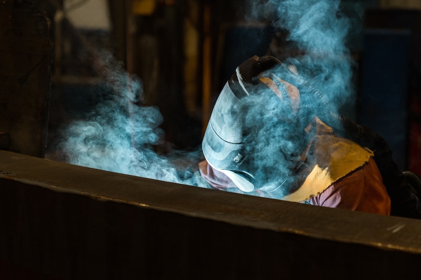 A worker welding at Hofmann Engineering.