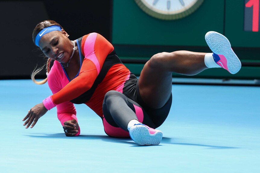 Serena Williams lies on her side, propped up by her right arm bent at the elbow, with one leg up in the air