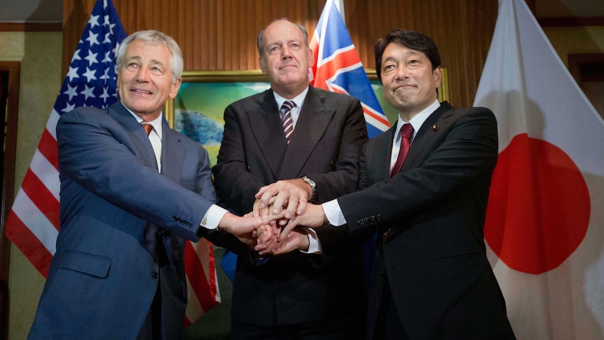 US, Japanese, and Australian defence ministers shake hands before the 2014 IISS Asia Security Summit