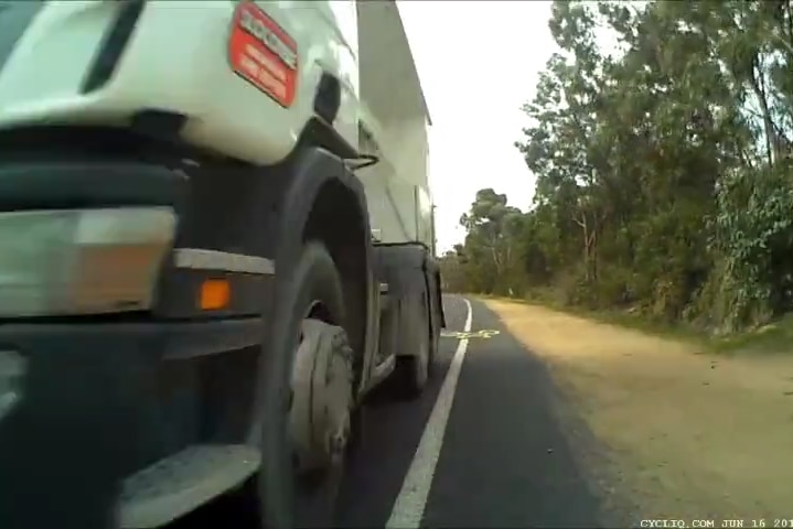 Truck comes within centimetres of cyclist