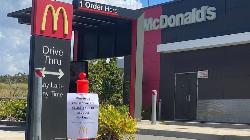 A McDonald's drive-thru with a sign in front of it blocking the entrance