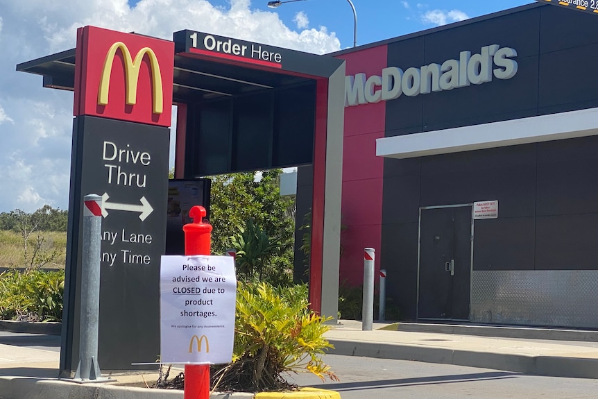 A McDonald's drive-thru with a sign in front of it blocking the entrace