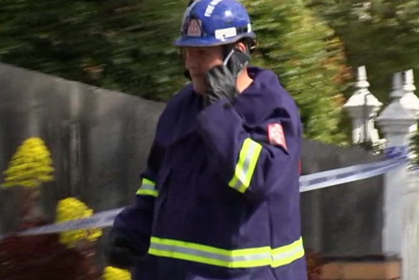 A firefighter speaks on a mobile phone.