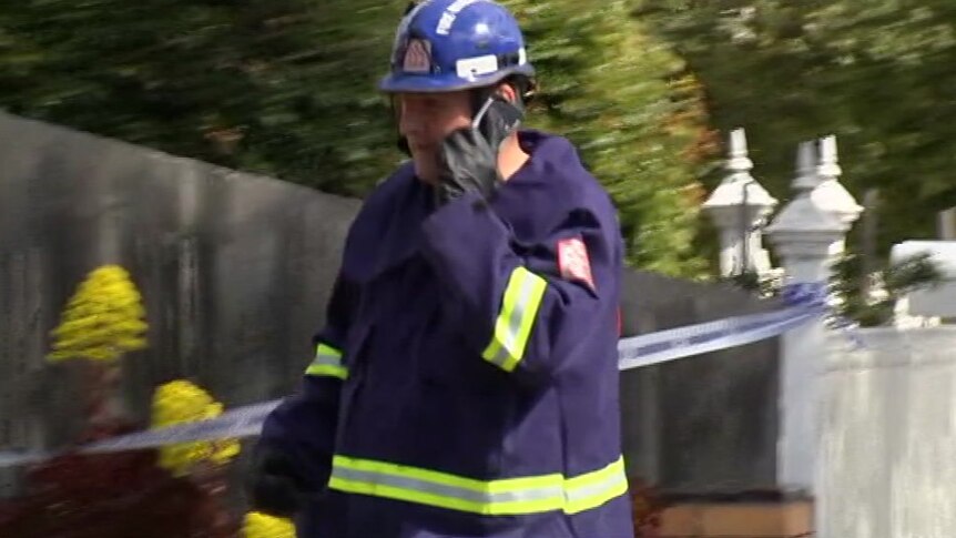 A firefighter speaks on a mobile phone.