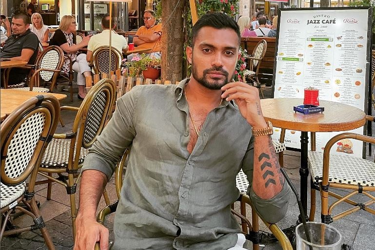 a man sitting at a cafe looking