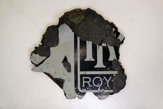 Corroded segment from MH370 engine cowling showing part of a Rolls Royce stencil.