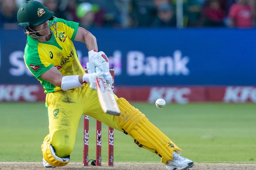 Down on one knee and moving away from the stumps, David Warner tries to scoop a delivery over his own head