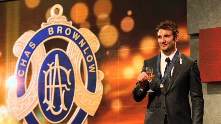November verdict ... Jobe Watson poses for photos with the Brownlow Medal in 2012
