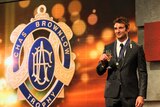 November verdict ... Jobe Watson poses for photos with the Brownlow Medal in 2012