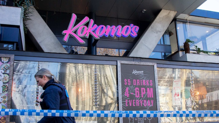 Police woman walks past Kokomo's