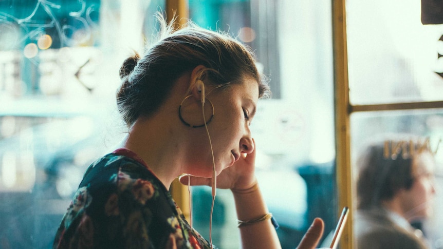 Woman wearing headphones.
