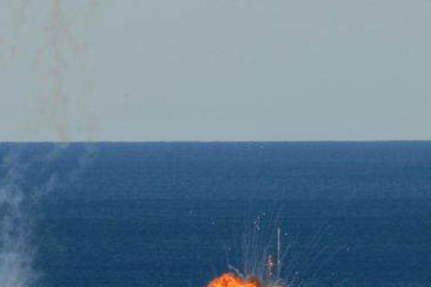 Flame erupts as HMAS Adelaide scuttling begins