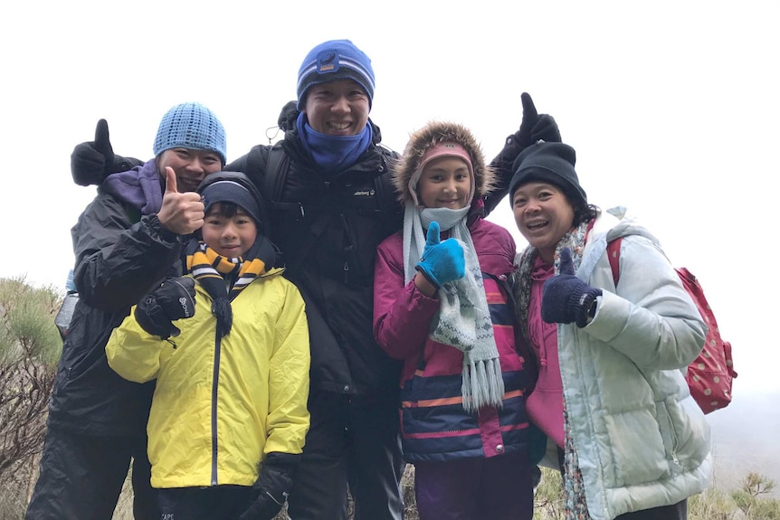 Agnes Kristina with her family stand on Bluff Knoll dresses in their winter woollies.