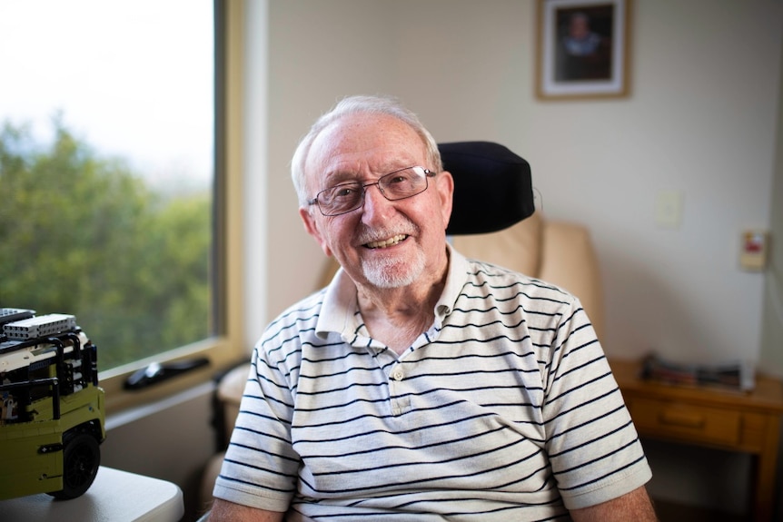 Aged care resident looks out a window 