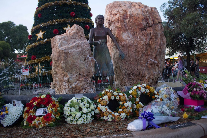 Wreaths surround the statue of St Barbara in central Kalgoorlie.